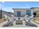 Relaxing backyard with fire pit and ample seating for outdoor entertaining at 20426 E Arroyo Verde Dr, Queen Creek, AZ 85142