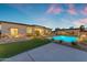 A picturesque backyard with a swimming pool, a covered patio, and lounge area at 20426 E Arroyo Verde Dr, Queen Creek, AZ 85142