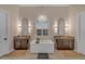 Luxurious bathroom with dual vanities, a soaking tub, and elegant lighting at 20426 E Arroyo Verde Dr, Queen Creek, AZ 85142
