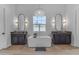 Bright bathroom with a standalone tub, chandelier, dual vanities, and modern fixtures at 20426 E Arroyo Verde Dr, Queen Creek, AZ 85142