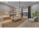 Cozy bedroom featuring a four-poster bed, soft lighting, and a large window at 20426 E Arroyo Verde Dr, Queen Creek, AZ 85142
