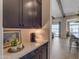 Elegant bar area features a marble countertop and dark wood cabinets at 20426 E Arroyo Verde Dr, Queen Creek, AZ 85142
