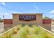 Landscaped entrance to Ellsworth Ranch features a decorative brick wall and community signage beneath a blue sky at 20426 E Arroyo Verde Dr, Queen Creek, AZ 85142