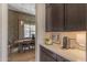 Elegant dining area featuring stylish wallpaper and a convenient coffee bar at 20426 E Arroyo Verde Dr, Queen Creek, AZ 85142