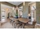 Open-concept dining room featuring a dining table, fireplace, and kitchen at 20426 E Arroyo Verde Dr, Queen Creek, AZ 85142