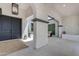 Inviting front entryway with double doors, stone flooring, and an outdoor living area at 20426 E Arroyo Verde Dr, Queen Creek, AZ 85142