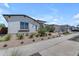View of a single-story home with desert landscaping, a black roof, and paved sidewalks at 20426 E Arroyo Verde Dr, Queen Creek, AZ 85142