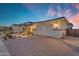 Beautiful home exterior featuring a three-car garage, a paver driveway, and professionally designed landscaping at 20426 E Arroyo Verde Dr, Queen Creek, AZ 85142