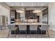 Modern kitchen with large island, pendant lighting, stainless steel appliances and dark wood cabinetry at 20426 E Arroyo Verde Dr, Queen Creek, AZ 85142