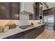 Modern kitchen with dark wood cabinets, white countertops, and stainless steel appliances at 20426 E Arroyo Verde Dr, Queen Creek, AZ 85142