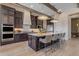 Spacious kitchen with modern appliances, a large island, sleek countertops, and ample seating at 20426 E Arroyo Verde Dr, Queen Creek, AZ 85142