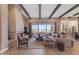 Spacious living room with a cozy fireplace, wood beams, and sliding doors to the patio at 20426 E Arroyo Verde Dr, Queen Creek, AZ 85142