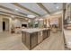 Spacious island kitchen overlooking a large living room with gorgeous fireplace and wood beams at 20426 E Arroyo Verde Dr, Queen Creek, AZ 85142