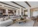Inviting living room featuring an open layout, stylish decor, and seamless flow to the kitchen and dining area at 20426 E Arroyo Verde Dr, Queen Creek, AZ 85142