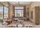 Bright living room featuring floor-to-ceiling windows, modern furniture, and stylish decor at 20426 E Arroyo Verde Dr, Queen Creek, AZ 85142