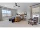 Bright main bedroom featuring a rattan bed frame, lots of natural light and a ceiling fan at 20426 E Arroyo Verde Dr, Queen Creek, AZ 85142