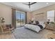 Bright main bedroom features a ceiling fan, calming colors, and sliding glass doors to the backyard at 20426 E Arroyo Verde Dr, Queen Creek, AZ 85142