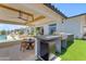 A modern outdoor kitchen is equipped with a grill, refrigerator, and dining area at 20426 E Arroyo Verde Dr, Queen Creek, AZ 85142