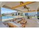 Covered patio with poolside view of outdoor seating area and beautiful landscaping at 20426 E Arroyo Verde Dr, Queen Creek, AZ 85142