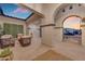 Covered patio with stylish seating, a striking water feature, and elegant decor for outdoor relaxation and comfort at 20426 E Arroyo Verde Dr, Queen Creek, AZ 85142
