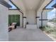 Inviting covered patio with elegant neutral stone flooring and comfortable seating area, perfect for outdoor relaxation at 20426 E Arroyo Verde Dr, Queen Creek, AZ 85142