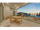 Elegant outdoor dining and entertaining area with pool views at 20426 E Arroyo Verde Dr, Queen Creek, AZ 85142