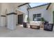 Cozy covered patio with plush seating, a sleek coffee table, and stylish faux greenery wall at 20426 E Arroyo Verde Dr, Queen Creek, AZ 85142