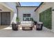 Stylish outdoor patio featuring comfortable seating, a modern coffee table, and attractive faux greenery wall at 20426 E Arroyo Verde Dr, Queen Creek, AZ 85142