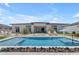 An inviting pool with a fire feature and lounge area offers a luxurious outdoor living space at 20426 E Arroyo Verde Dr, Queen Creek, AZ 85142