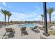 Community pool with lounge chairs and lush landscaping, a perfect spot for relaxation and recreation at 20426 E Arroyo Verde Dr, Queen Creek, AZ 85142
