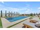 A stunning pool features a striped umbrella, lounge chairs, and manicured landscaping at 20426 E Arroyo Verde Dr, Queen Creek, AZ 85142