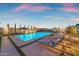 Serene backyard featuring a sparkling pool, sun loungers, and manicured landscaping offer a private outdoor oasis at 20426 E Arroyo Verde Dr, Queen Creek, AZ 85142
