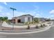 Neighborhood street view of a single-story home with desert landscaping and paved sidewalks at 20426 E Arroyo Verde Dr, Queen Creek, AZ 85142
