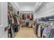 Large walk-in closet featuring ample shelving, clothing racks, and a patterned rug at 20426 E Arroyo Verde Dr, Queen Creek, AZ 85142