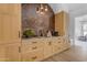 Wet bar featuring wood cabinets, a stylish backsplash, and modern fixtures at 20426 E Arroyo Verde Dr, Queen Creek, AZ 85142