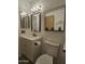 The bathroom features a sink, vanity, toilet, and modern mirrors, creating a stylish and functional space at 2123 E Kirkland Ln # 3, Tempe, AZ 85281