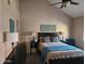 The bedroom is complete with a bed, nightstands, lamps, dresser, and a teal accent chair at 2123 E Kirkland Ln # 3, Tempe, AZ 85281