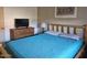 The bedroom features a wooden bed frame, dresser, and TV, creating a rustic and cozy atmosphere at 2123 E Kirkland Ln # 3, Tempe, AZ 85281