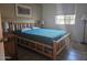 This bedroom has a wooden bed frame and a window with blinds, making it the perfect place to unwind at 2123 E Kirkland Ln # 3, Tempe, AZ 85281