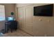Small bedroom with desk, large closet, and mounted television at 2123 E Kirkland Ln # 3, Tempe, AZ 85281