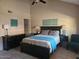 The bedroom is complete with a bed, nightstands, lamps, dresser, and a teal accent chair at 2123 E Kirkland Ln # 3, Tempe, AZ 85281