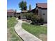 Beautifully landscaped pathway leading to townhome with red tile roof and manicured greenery at 2123 E Kirkland Ln # 3, Tempe, AZ 85281