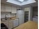 View of kitchen with stainless appliances, pantry, and laundry area at 2123 E Kirkland Ln # 3, Tempe, AZ 85281