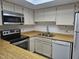 Functional kitchen with white appliances and countertops, complemented by wood-look floors at 2123 E Kirkland Ln # 3, Tempe, AZ 85281