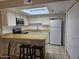 Bright kitchen features skylight, stainless appliances and breakfast bar at 2123 E Kirkland Ln # 3, Tempe, AZ 85281