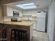 Bright kitchen featuring white cabinetry, a skylight, and efficient appliances at 2123 E Kirkland Ln # 3, Tempe, AZ 85281