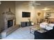 Open concept living room with fireplace and view into the dining area and kitchen at 2123 E Kirkland Ln # 3, Tempe, AZ 85281