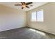 Cozy bedroom featuring a ceiling fan, a large window and carpeted floors at 2129 E Yuma Ave, Apache Junction, AZ 85119