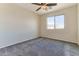 Comfortable bedroom showcasing plush carpeting, a ceiling fan, and a bright window at 2129 E Yuma Ave, Apache Junction, AZ 85119