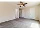 A clean bedroom with neutral tones, a ceiling fan, and plush carpeting at 2129 E Yuma Ave, Apache Junction, AZ 85119